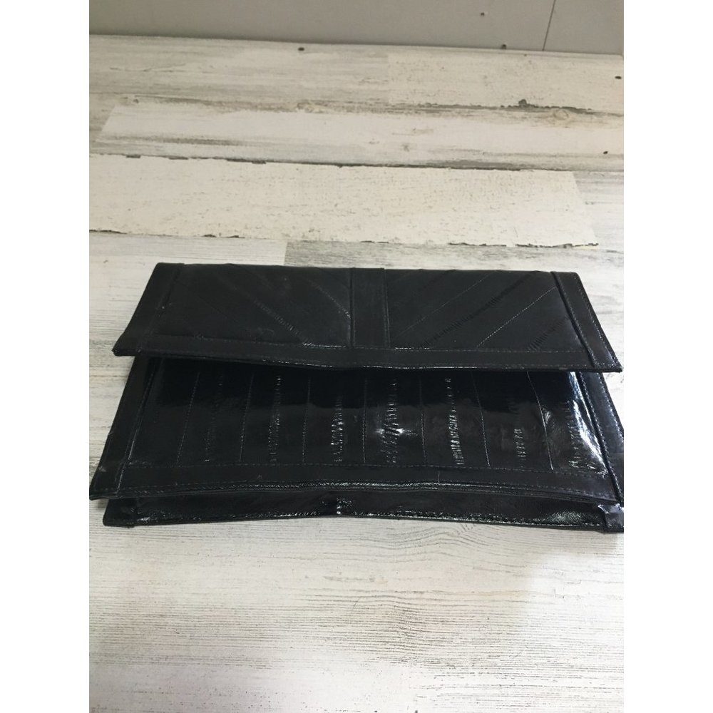 Eel skin black clutch bag with snap closure